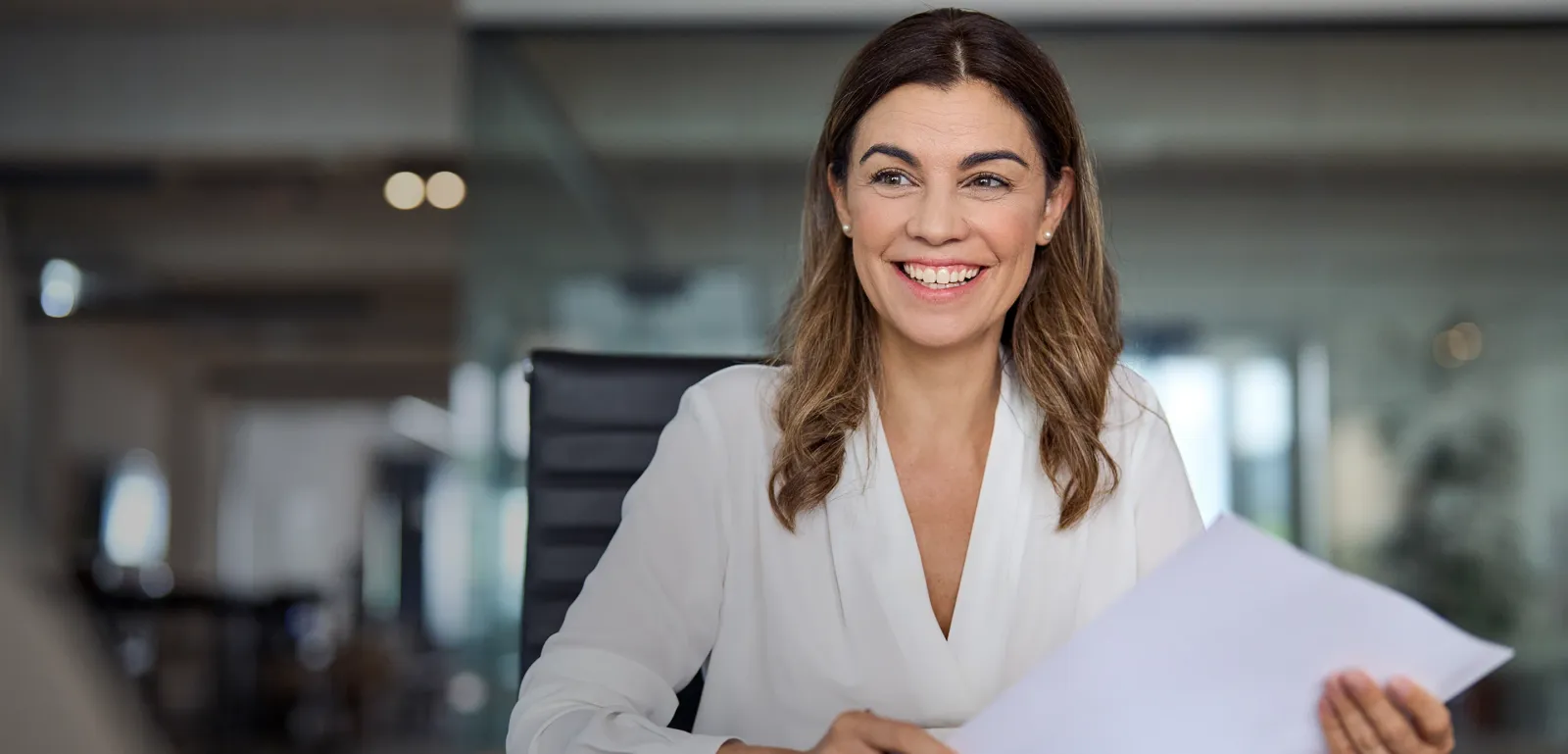 A partner at her desk with a signed agreement