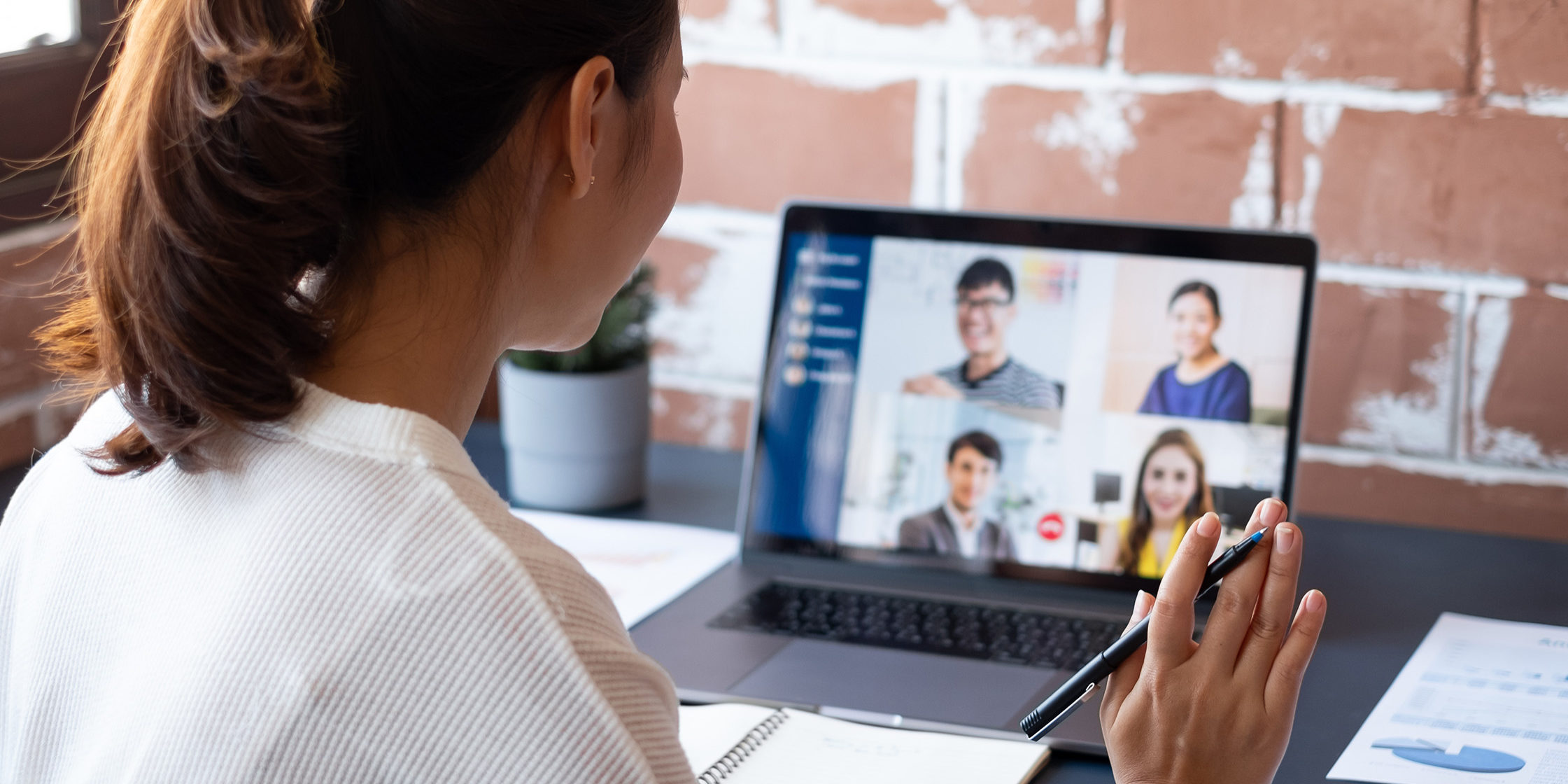 Young Asian businesswoman work at home and virtual video conference meeting with colleagues business people, online working, video call due to social distancing at home office